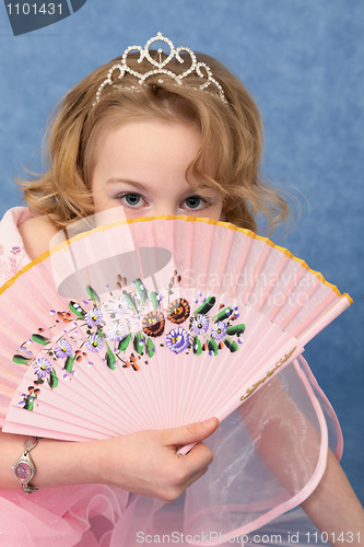 Image of Girl coyly covered face with fan