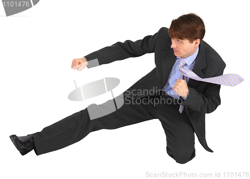 Image of Businessman kicks forward on white background