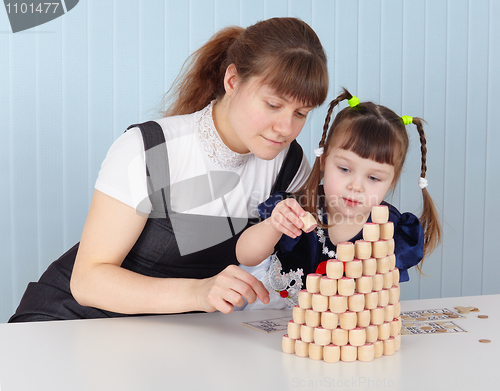 Image of Mother and daughter building tower of bingo