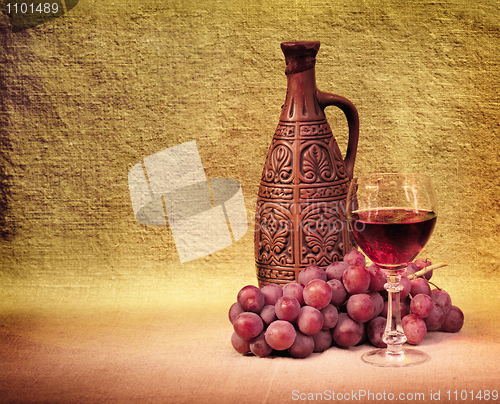 Image of Artistic arrangement of bottles of wine and grapes