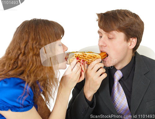 Image of Man and woman eating sausage