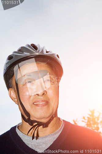 Image of Senior asian man with bike helmet
