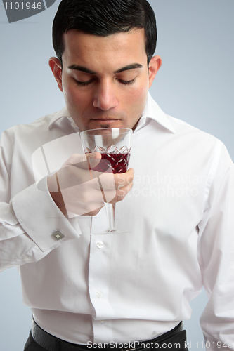 Image of Man smelling red wine