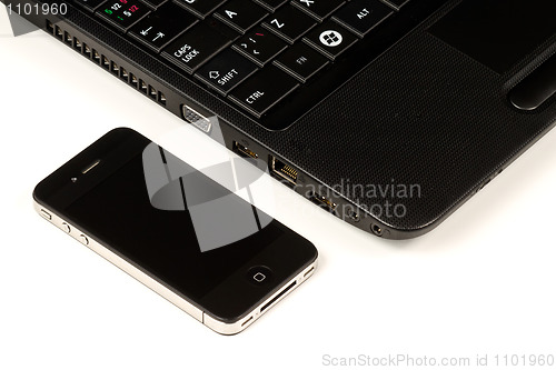 Image of Smartphone and laptop on white background