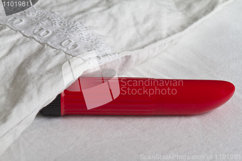 Image of Red vibrator in bed