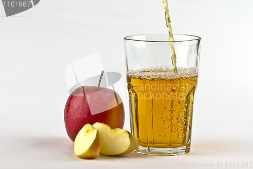 Image of Apple cider pouring down into glass