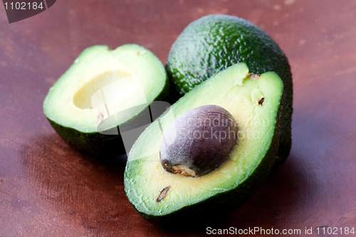 Image of Avocados on a wooden background