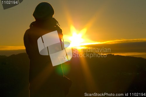 Image of Person taking pictures of sunset