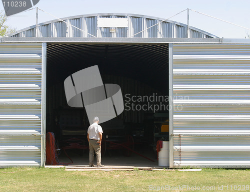 Image of man and metal building