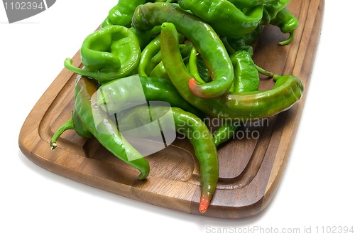 Image of Hot peppers on kitchen board