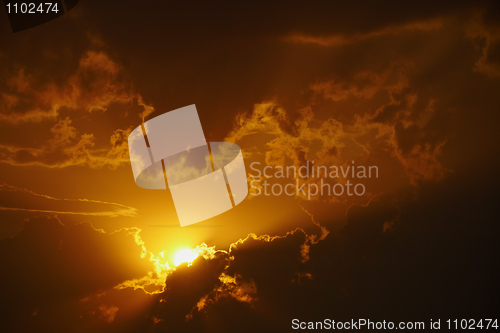 Image of Bright orange sunset in clouds