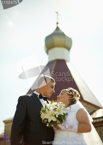 Image of Bride and groom on background of Christian Church