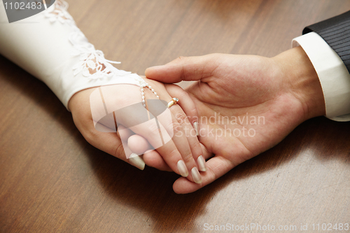 Image of Hands of newly-married couple