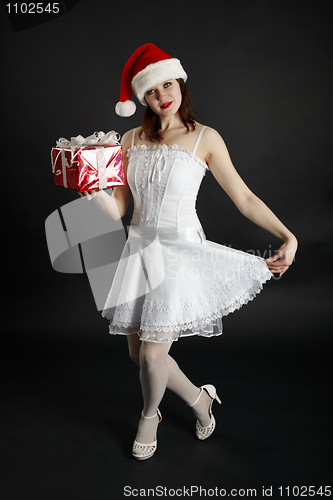 Image of Girl in Christmas hat with gifts