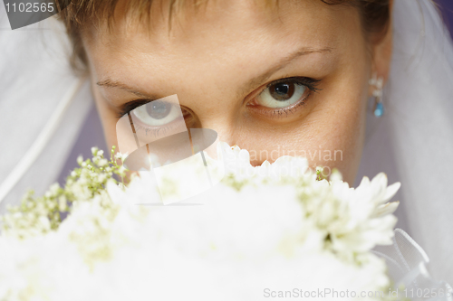 Image of Eyes of bride and bridal bouquet