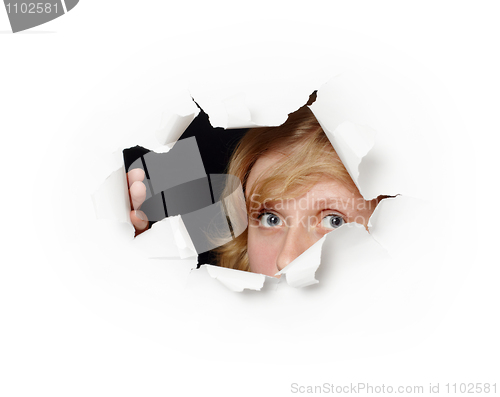 Image of Face peeping out of hole - female curiosity