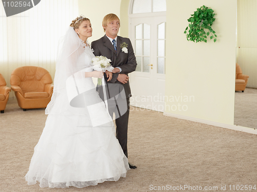 Image of Groom with bride in ceremonial hall