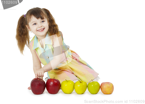 Image of Little girl playing with fruits