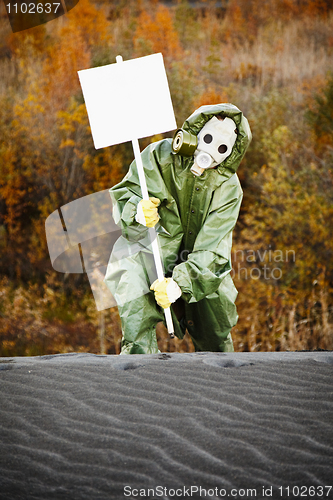 Image of Scientist in gas mask with poster