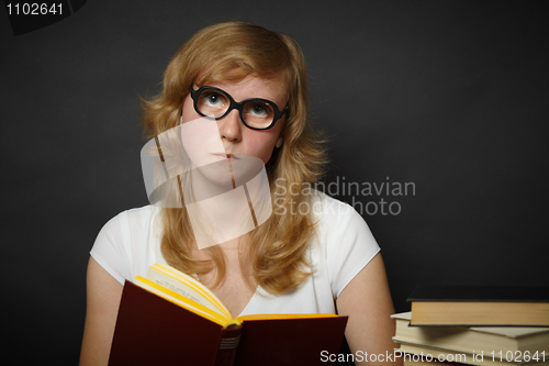 Image of Well-read woman looks through spectacles