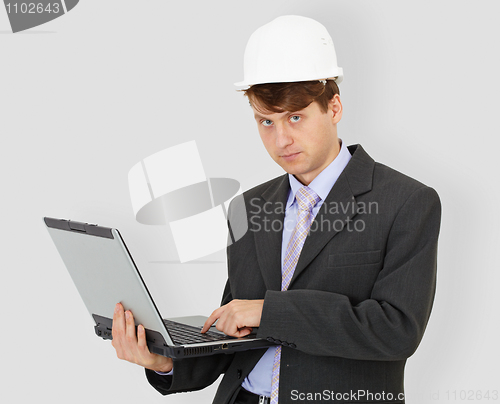 Image of Construction superintendent with computer in hands on grey backg
