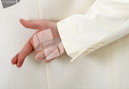 Image of Fingers crossed behind back - white suit