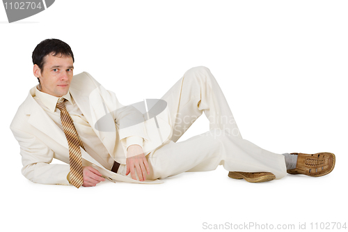 Image of Handsome young man in suit lying on white