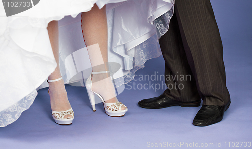 Image of Feet of groom and bride - wedding composition