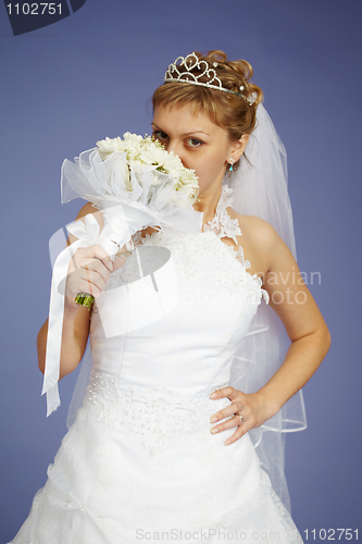 Image of Young Bride smell the flowers