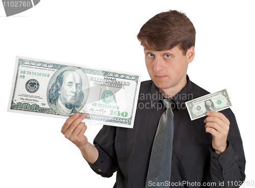 Image of Young man holding large and small money