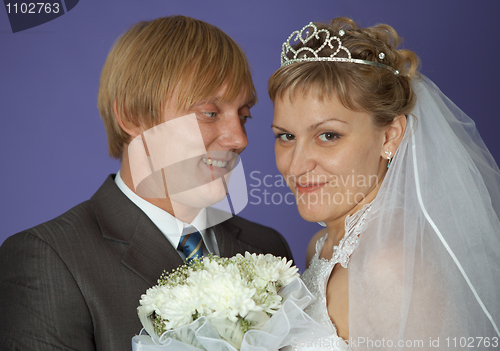 Image of Bride and groom on purple background