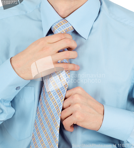 Image of Business man adjust beautiful new tie