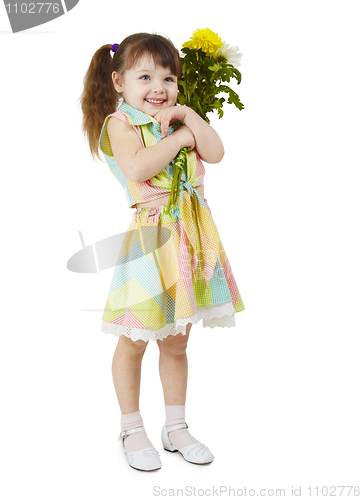 Image of Happy little girl holds bouquet of flowers