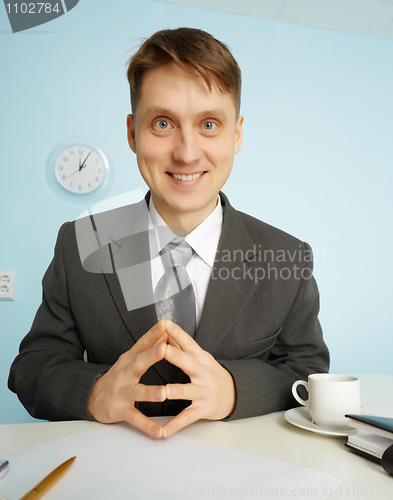 Image of Happy clerk sitting with smile