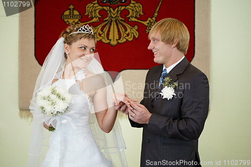 Image of Bride and groom on background of coat of arms