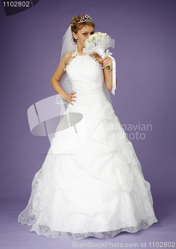 Image of Bride in white dress with bouquet