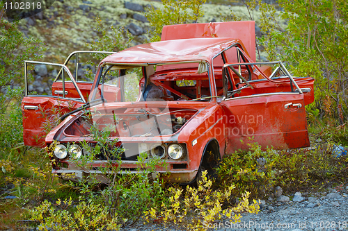 Image of Broken in accident, half-rotten old car