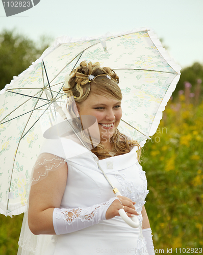 Image of Happy bride with a parasol