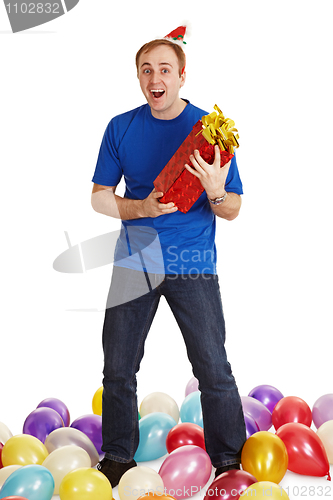 Image of Cheerful man with New Year's gift in hands