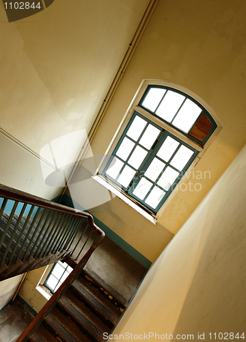 Image of Looking down at an old wooden stairs at an abandoned building