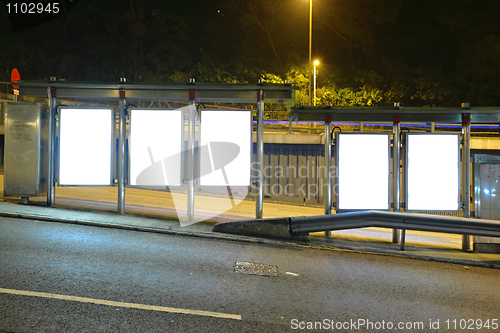 Image of Blank billboard on bus stop at night
