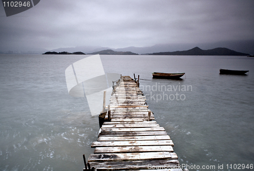 Image of pier and boat, low saturation