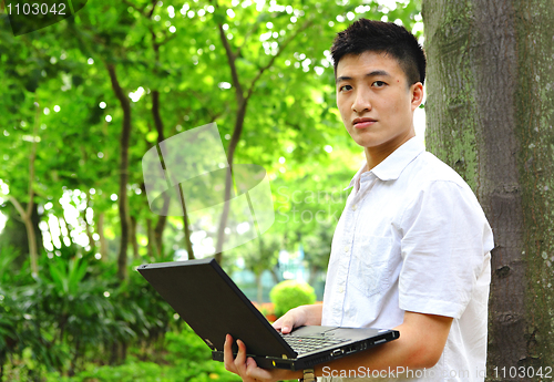 Image of man using computer outdoor