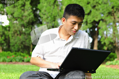 Image of man use laptop in park