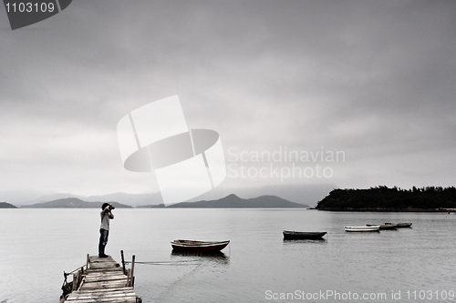 Image of lonely man taking photo