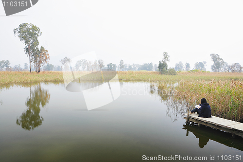 Image of wetland with lonely girl