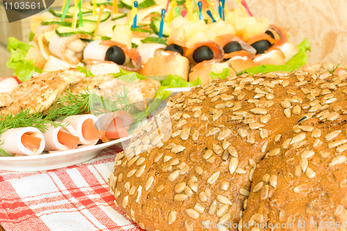 Image of Meat, canape and Bread with seeds on table