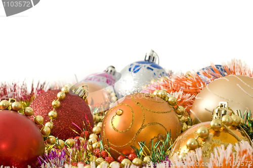 Image of Christmas greeting decoration - colorful baubles and tinsel 