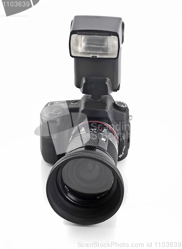 Image of Professional DSLR camera with telephoto lens and flash