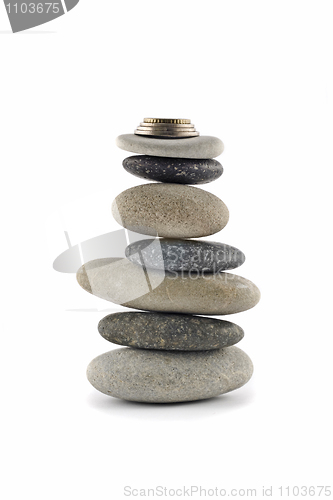 Image of Welfare and Stability  - Balanced stone stack with coins